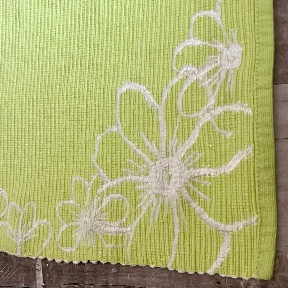 Lime green and white embroidered fabric placemats